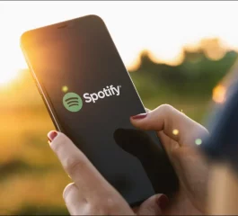 person-using-a-smartphone-with-the-spotify-logo-on-it